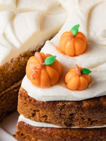 A close-up of marzipan pumpkins on top of a cake
