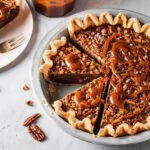 Pecan pie made without corn syrup with caramel swirled on top