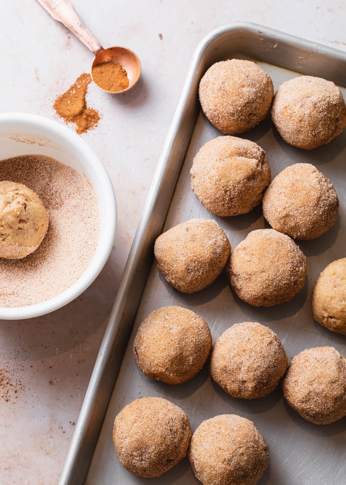 Preparing snickerdoodles on a cookie sheet