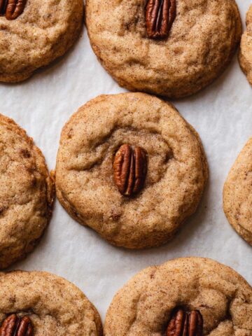 Baked pecan snickerdoodles on parchment paper