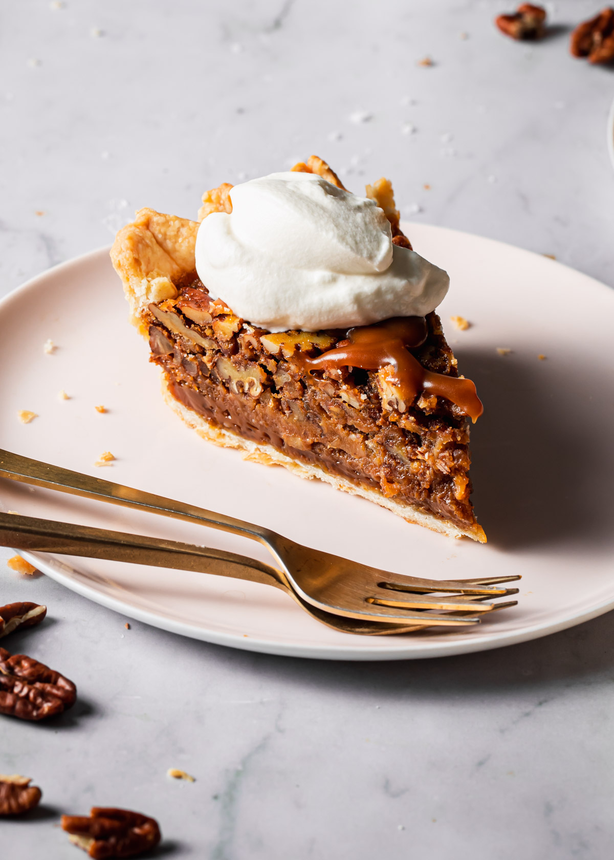 A slice of pecan pie with whipped cream on top