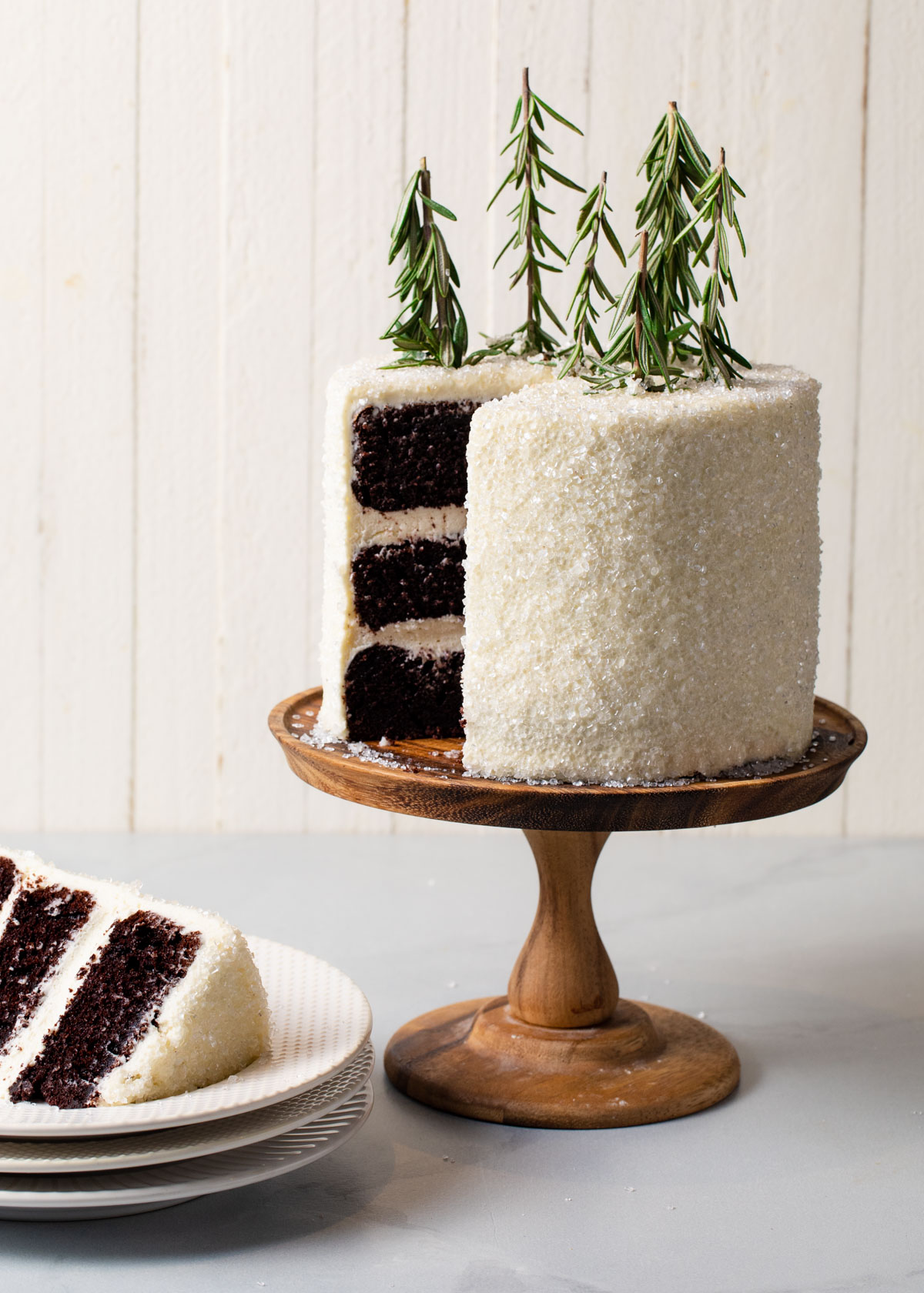 A chocolate layer cake with peppermint buttercream and rosemary trees on top