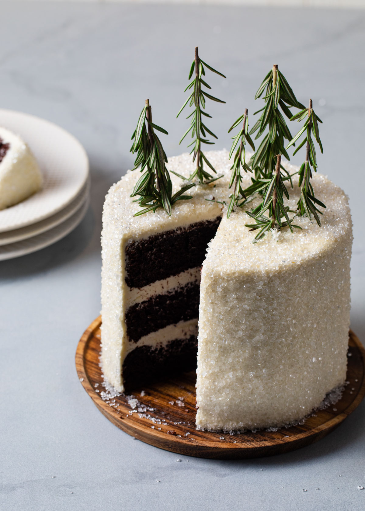 A chocolate layer cake with peppermint buttercream and rosemary trees on top