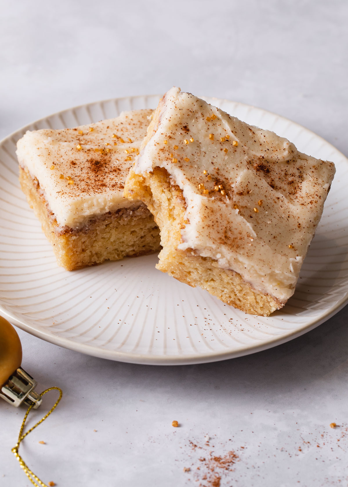 Snickerdoodle cookie bars with frosting on a plate