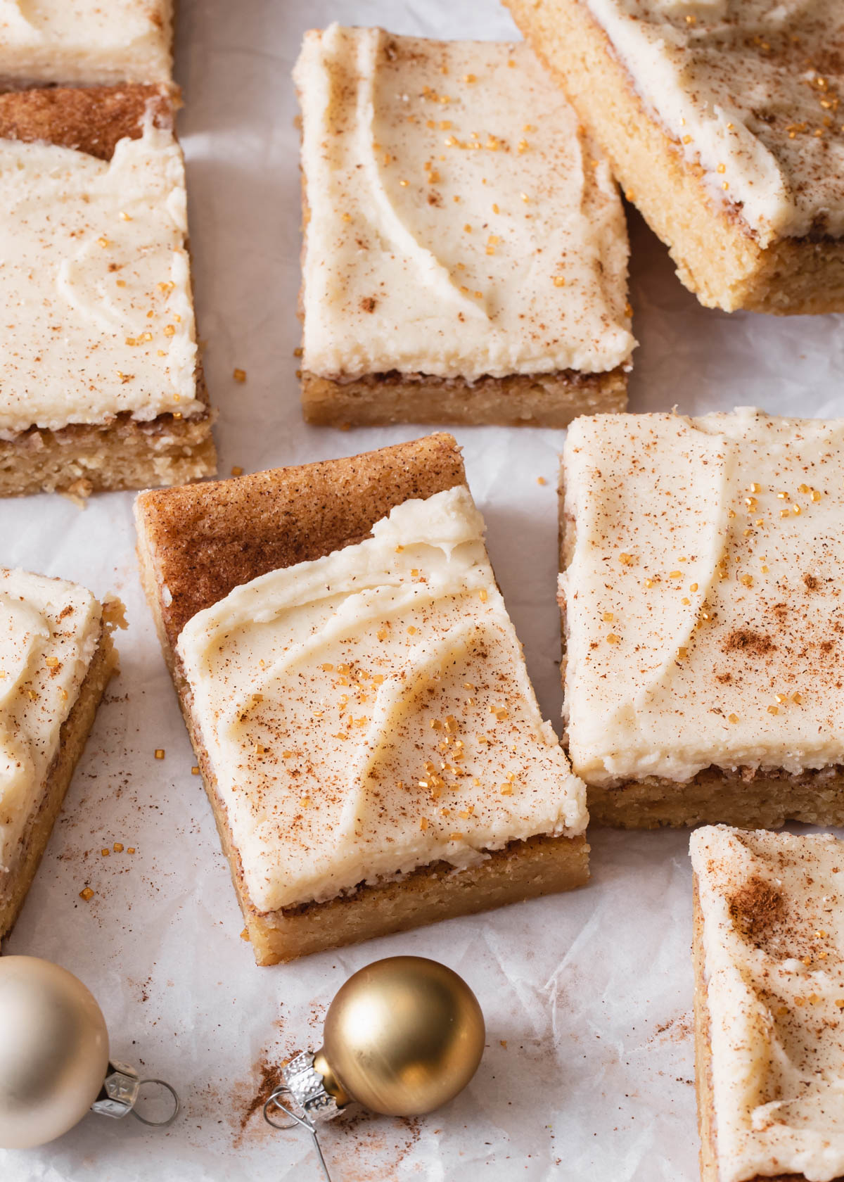 Cut up snickerdoodle cookie bars with icing on top
