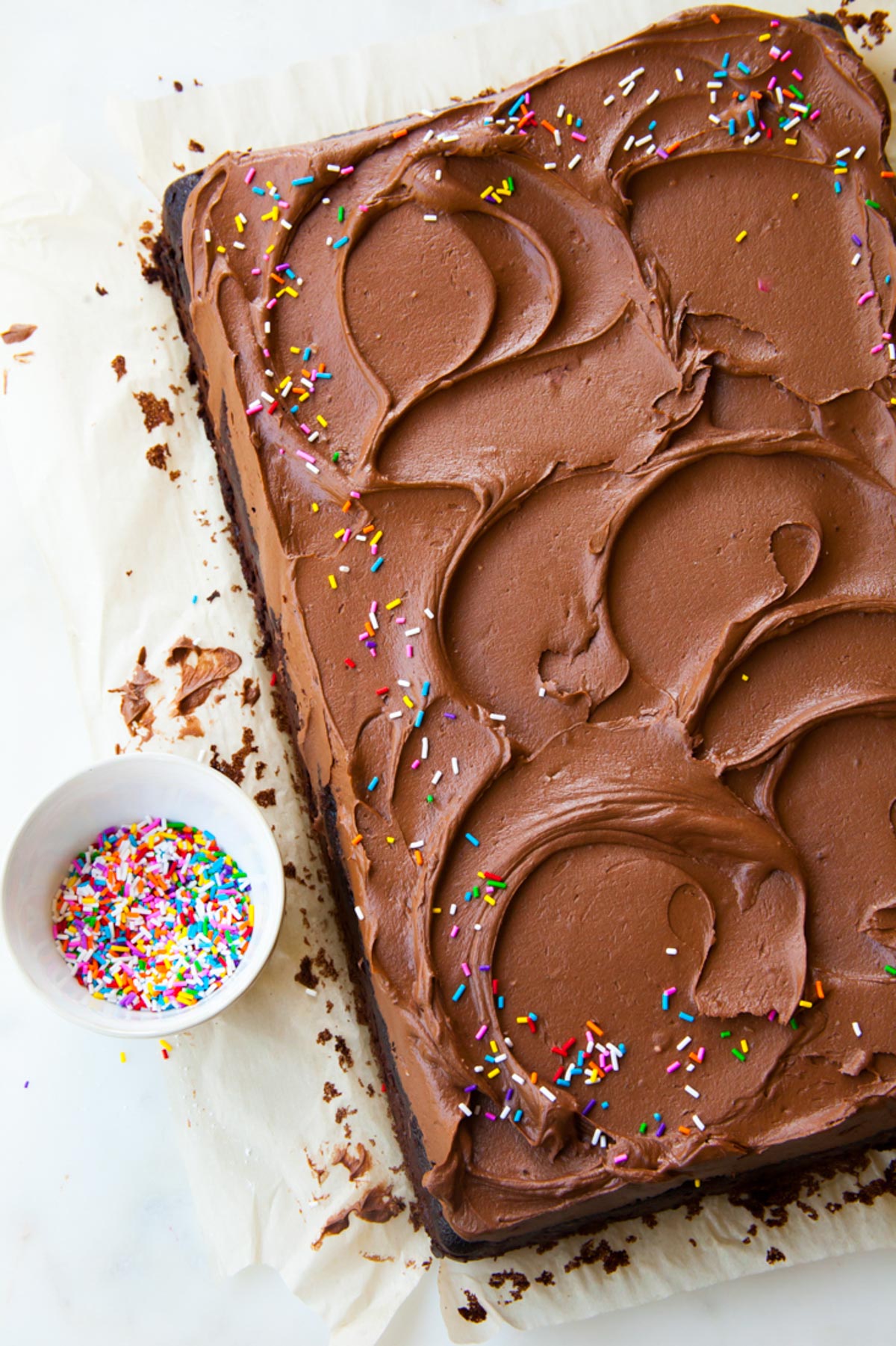 Easy chocolate sheet cake with swirls of fudge frosting on top