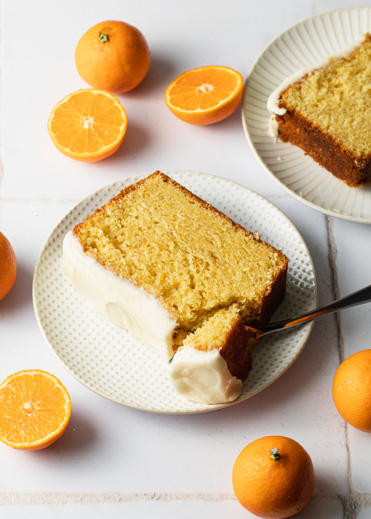 A slice of orange pound cake with vanilla glaze on top