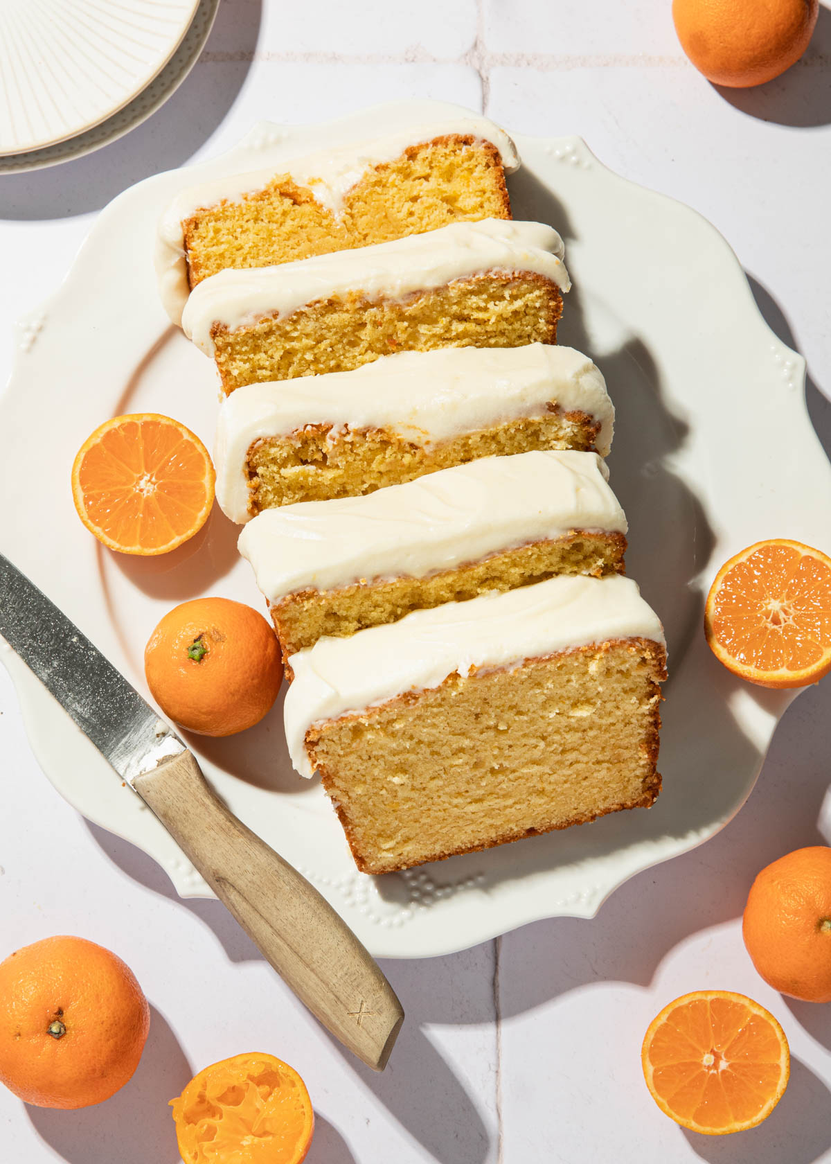 Slices of orange pound cake on a white serving dish