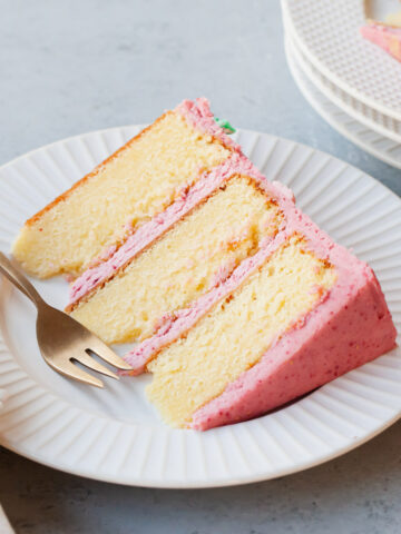 A slice of layered raspberry almond cake