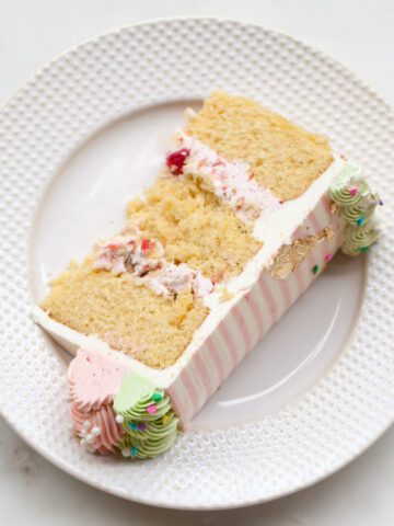 A slice of rhubarb crisp cake with pink stripe buttercream