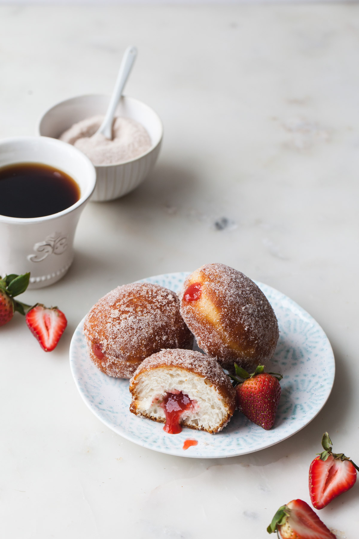 A plate of strawberry rhubarb filled donuts