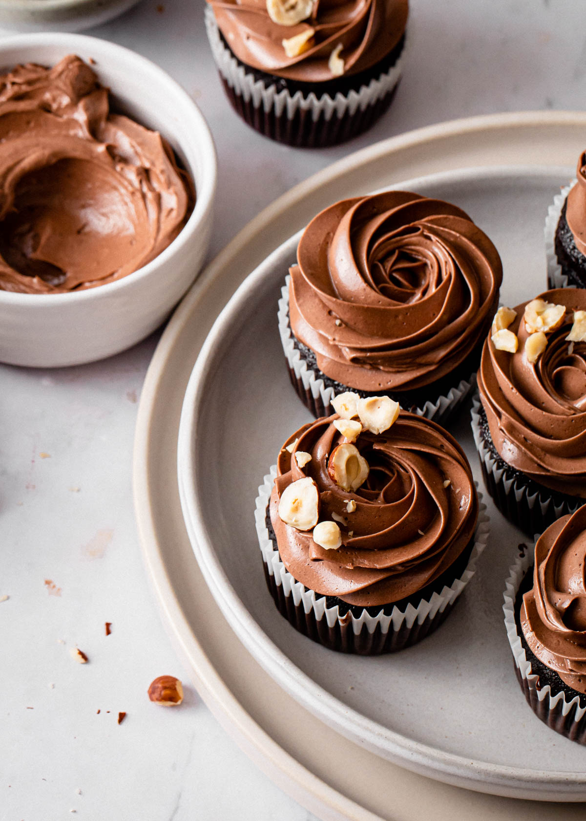 An overhead of Chocolate Nutella Cupcakes with hazelnuts on top