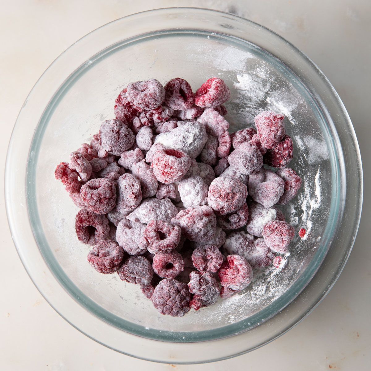 Tossed frozen raspberries with flour