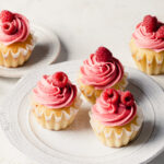 Cupcakes with pink raspberry buttercream and fresh raspberries