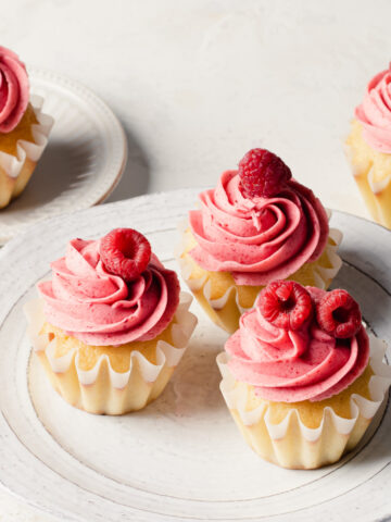 Cupcakes with pink raspberry buttercream and fresh raspberries