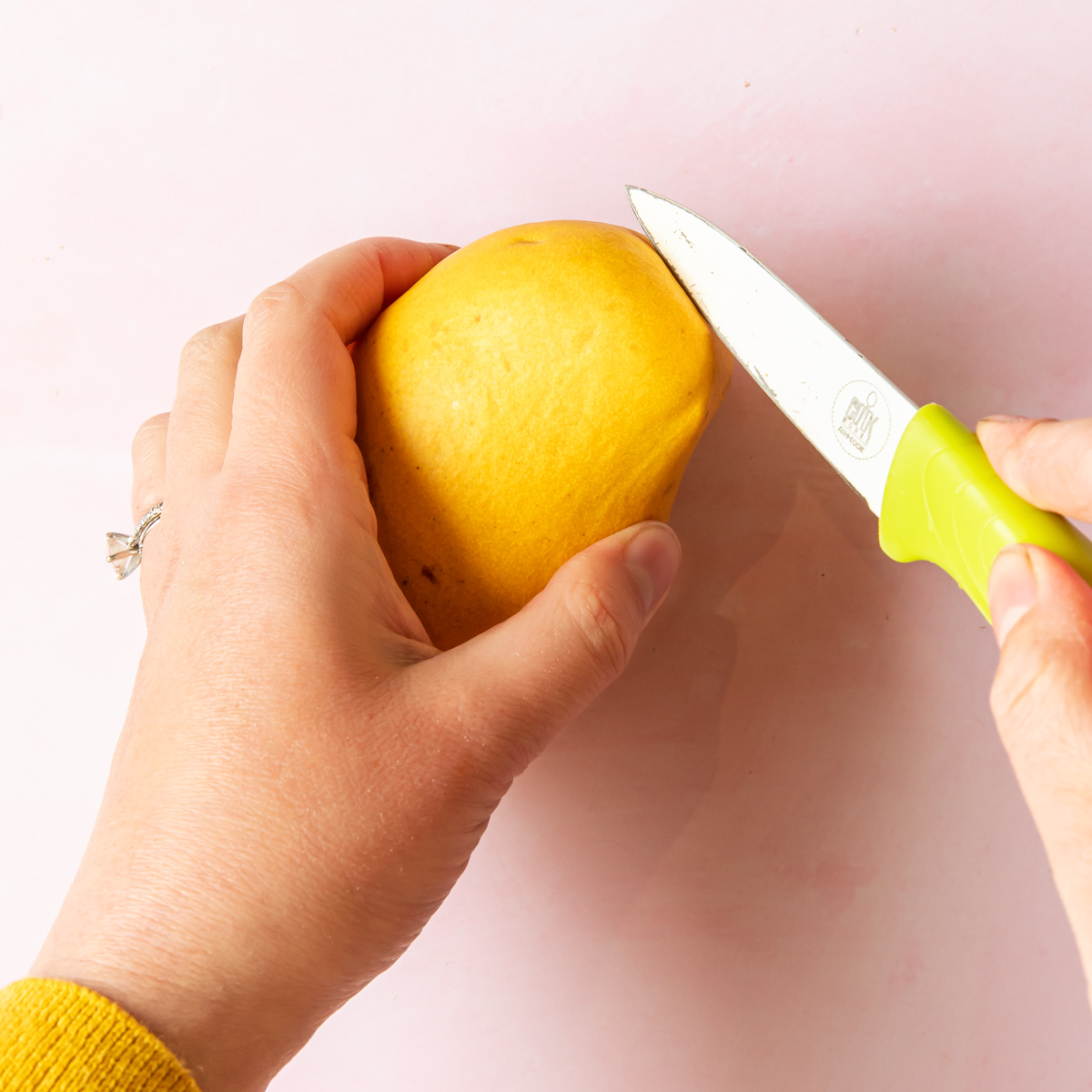 cutting open a mango