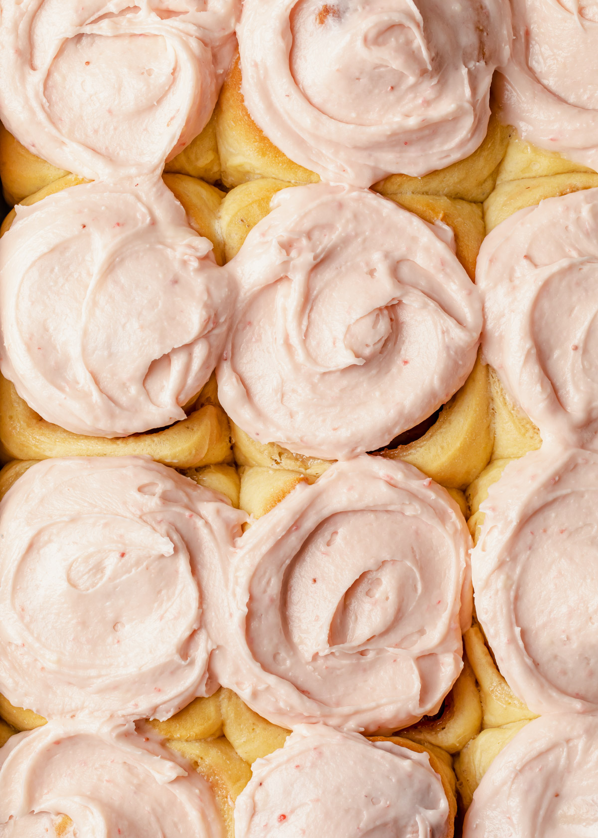 Pink frosted strawberry cinnamon rolls