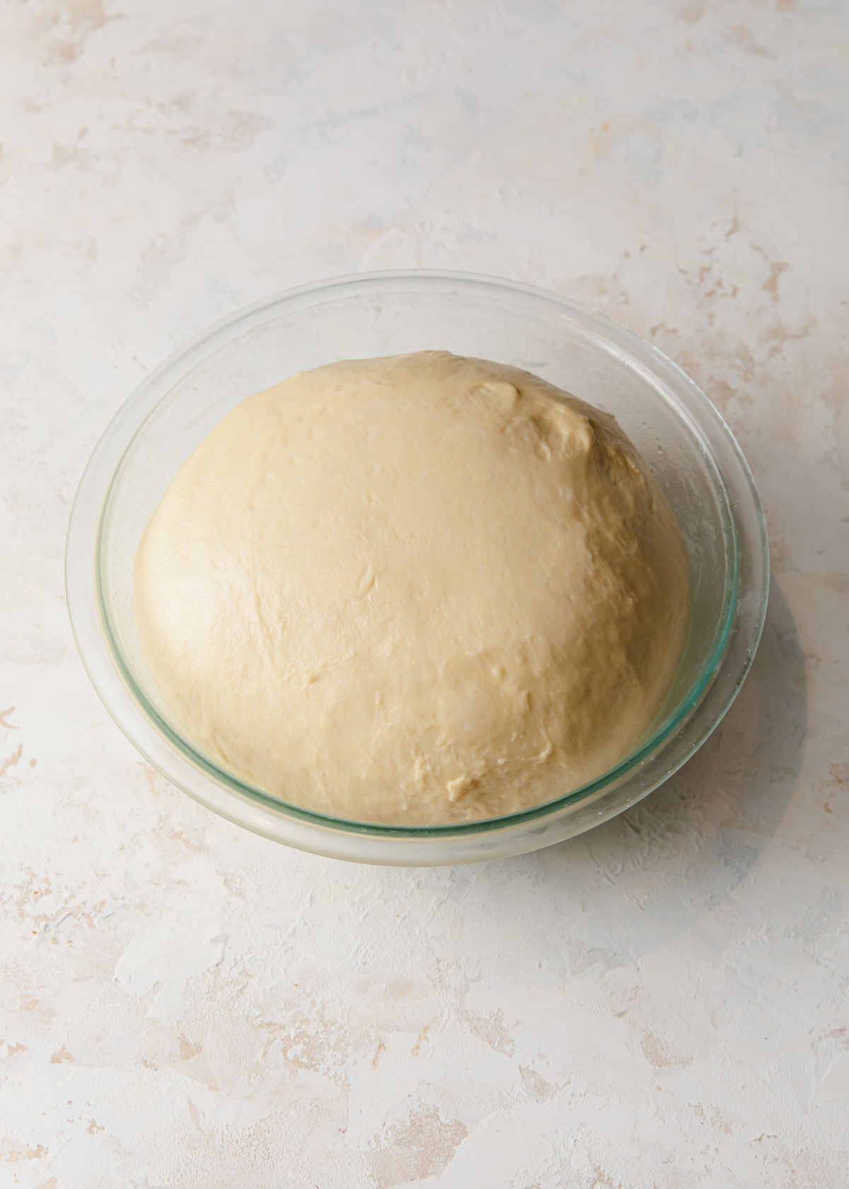 Proofed milk bread dough for cinnamon rolls in a bowl.