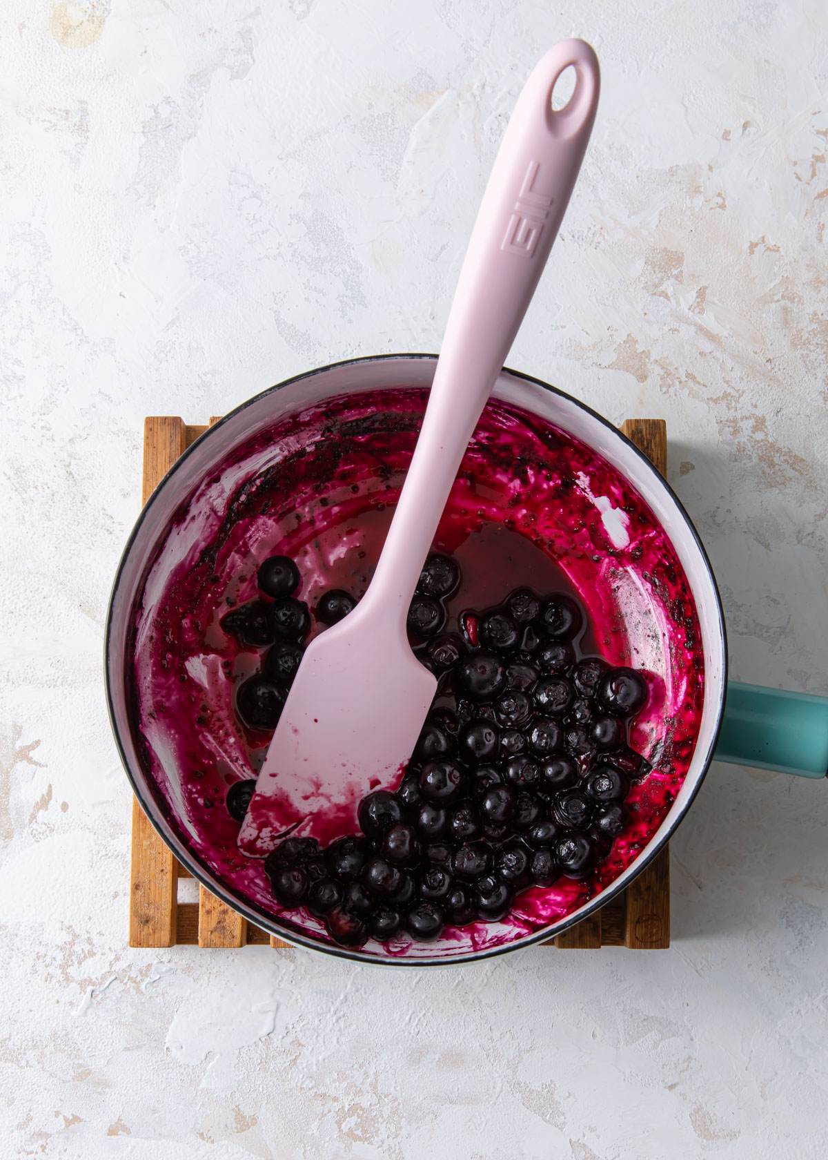 Blueberry sauce being cooked down in a pot