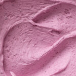 A close-up of bright, fluffy blueberry buttercream frosting