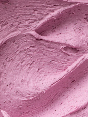 A close-up of bright, fluffy blueberry buttercream frosting