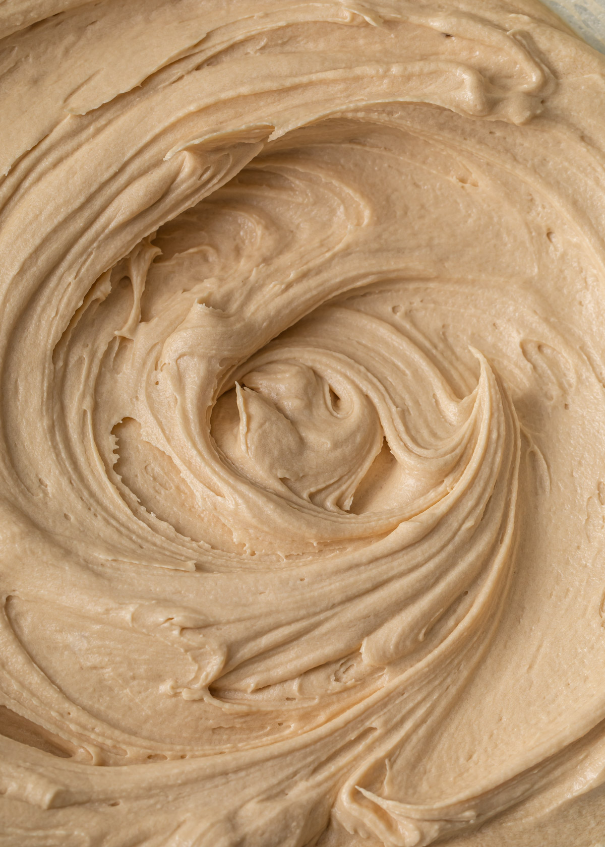 A close up of swirls of coffee buttercream