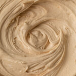 A close up of swirls of coffee buttercream