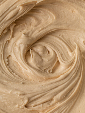 A close up of swirls of coffee buttercream