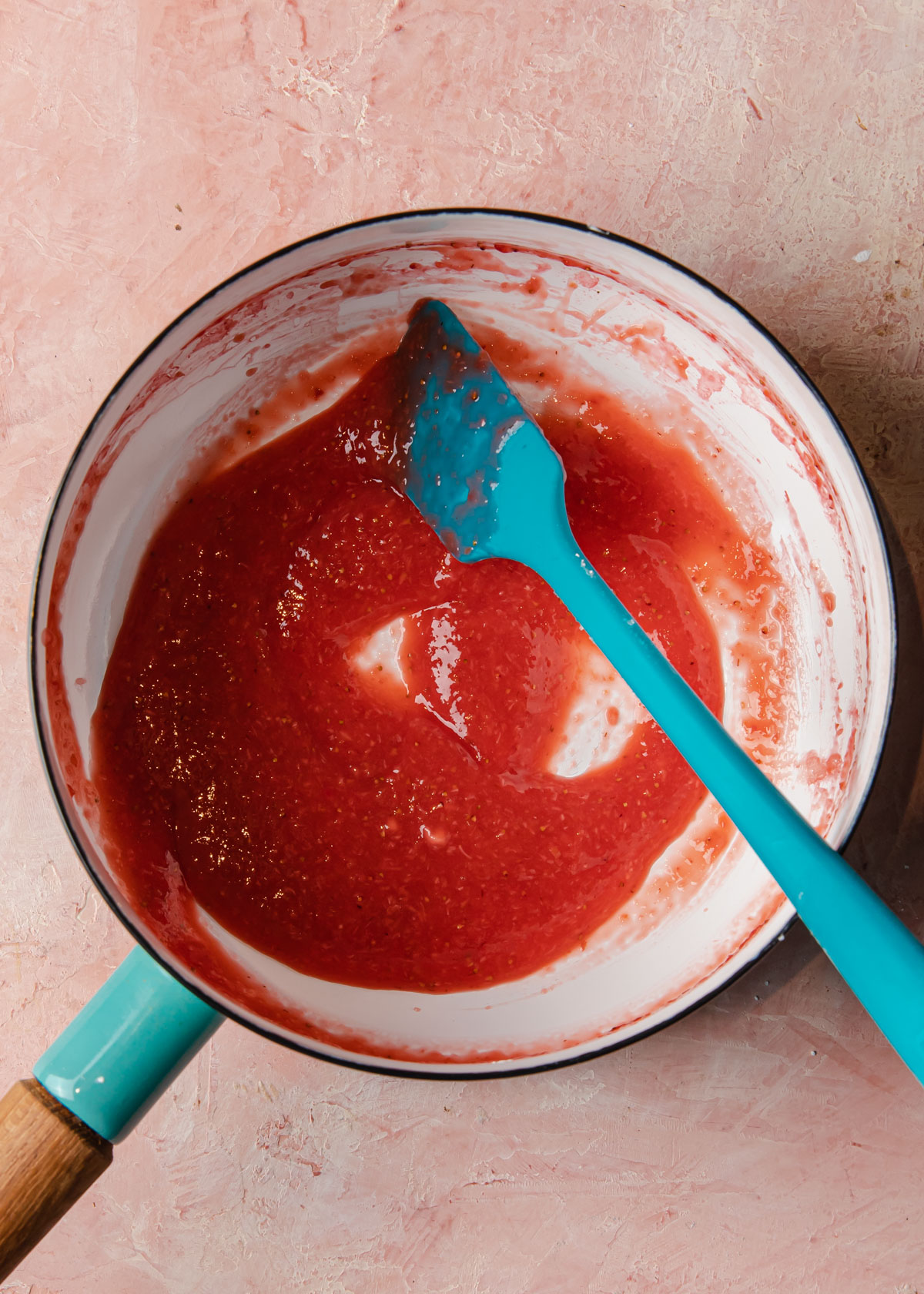 Thickened strawberry sauce in a pan