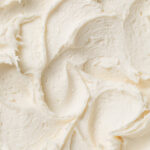 A close up of fluffy almond buttercream frosting