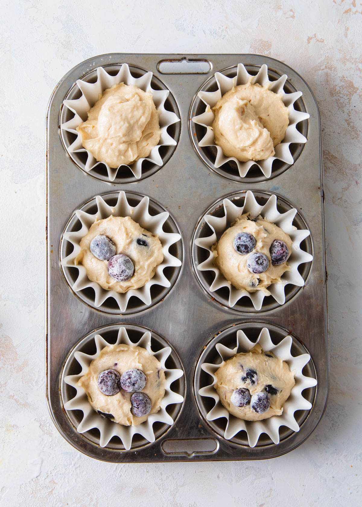 Blueberry cupcake batter in cupcake pans