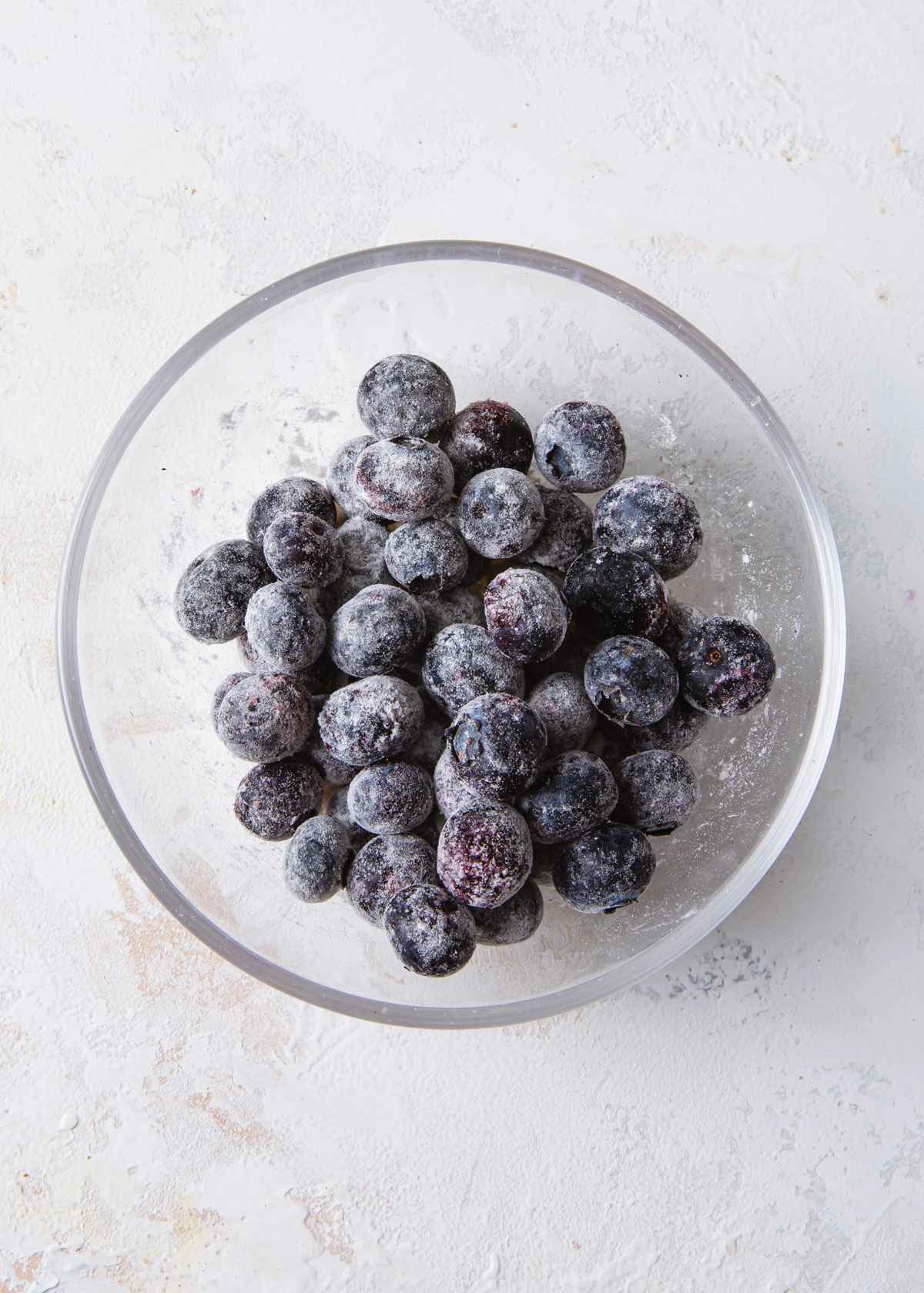 A bowl of blueberries tossed in flour