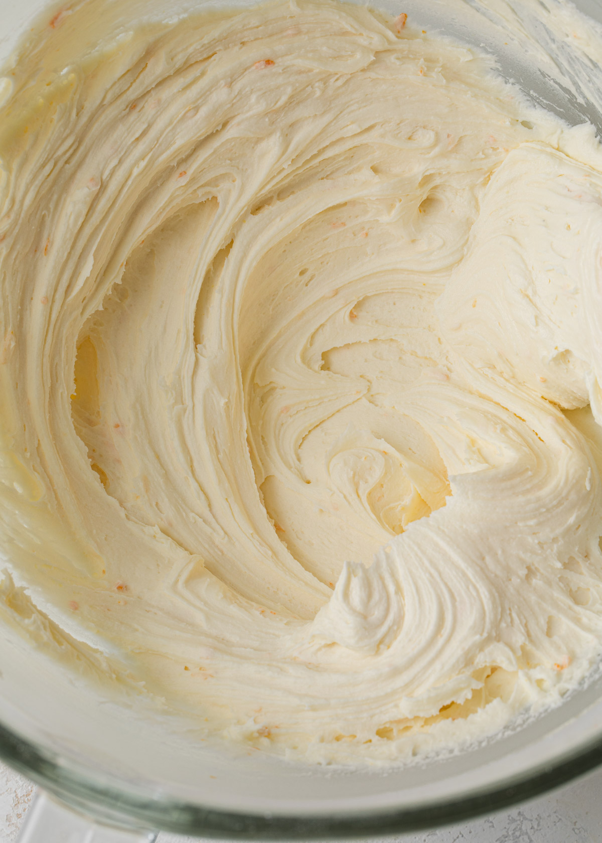 A close up of whipped orange buttercream