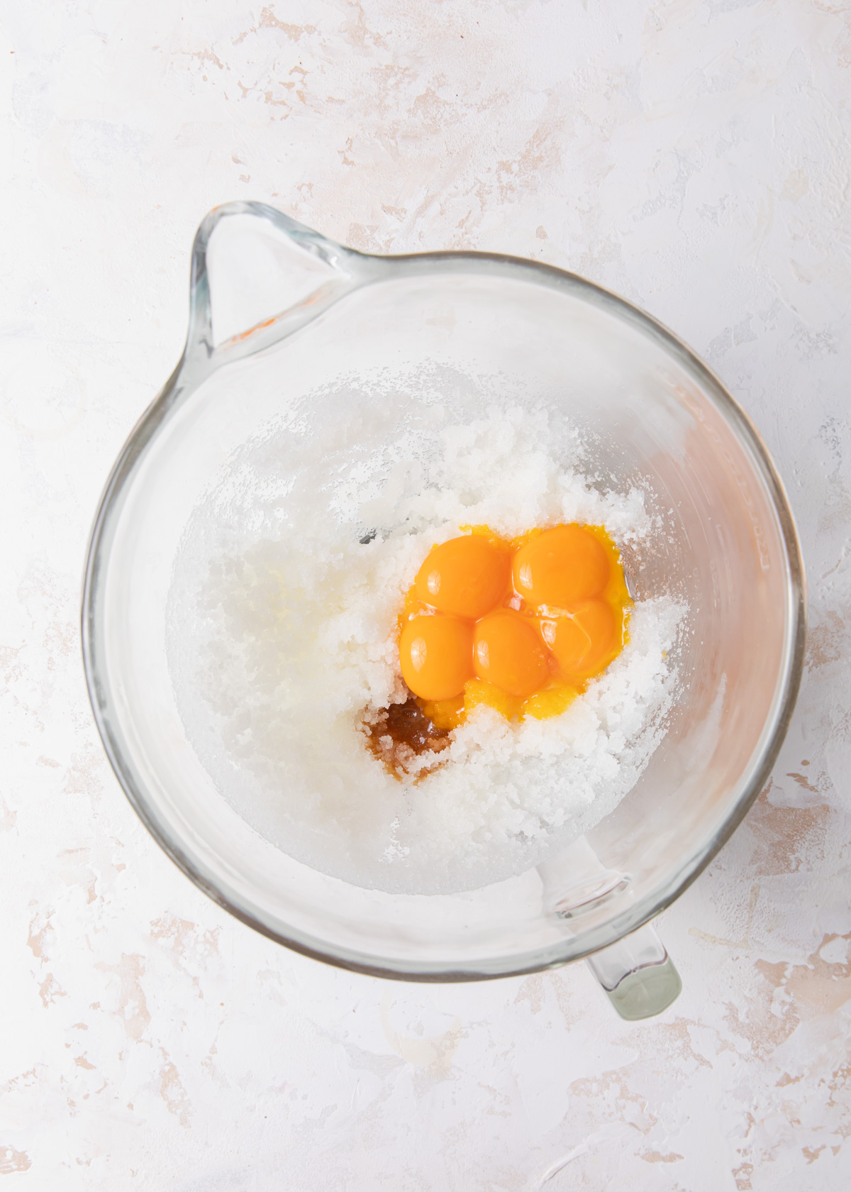 Sugar, oil, vanilla, and egg yolks in a mixing bowl