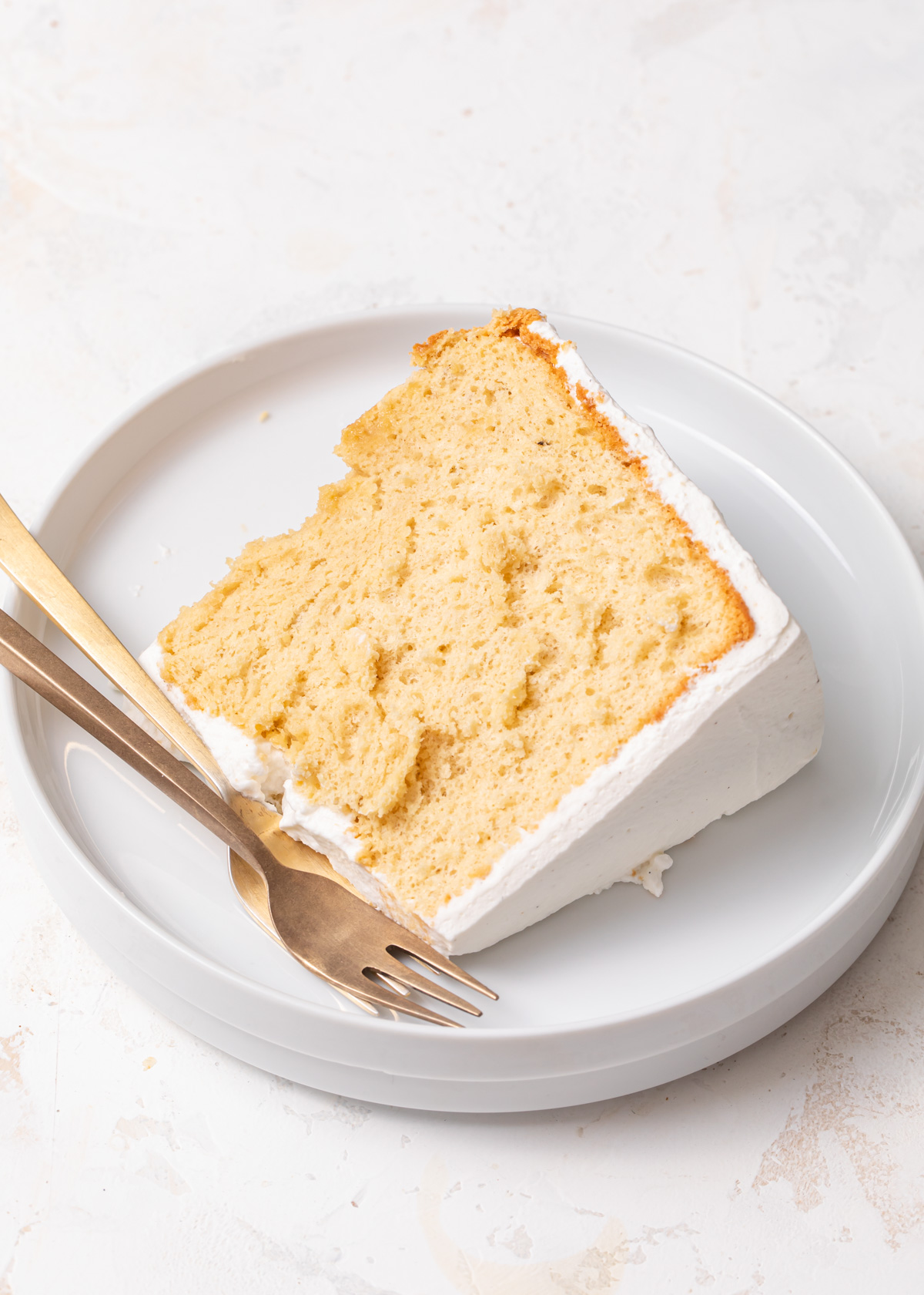 A close-up of a slice of fluffy vanilla chiffon cake