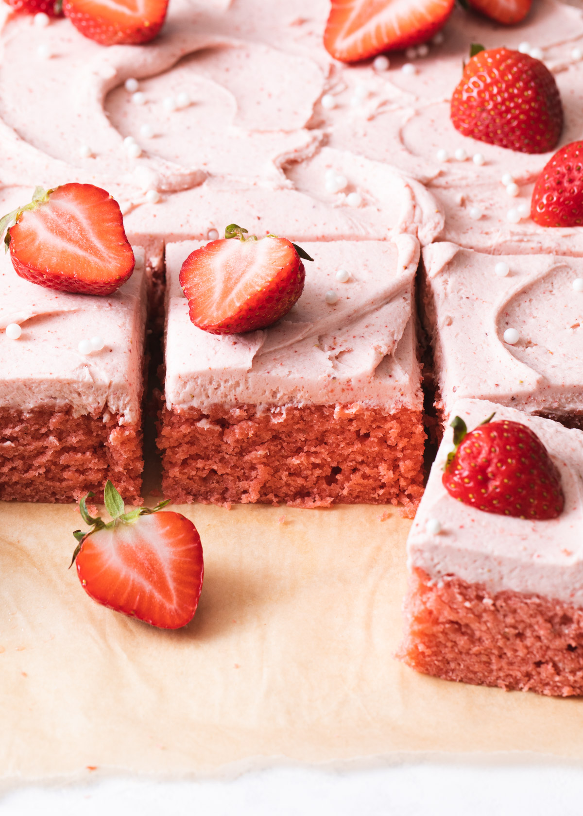 A close-up of slices of strawberry snack cake