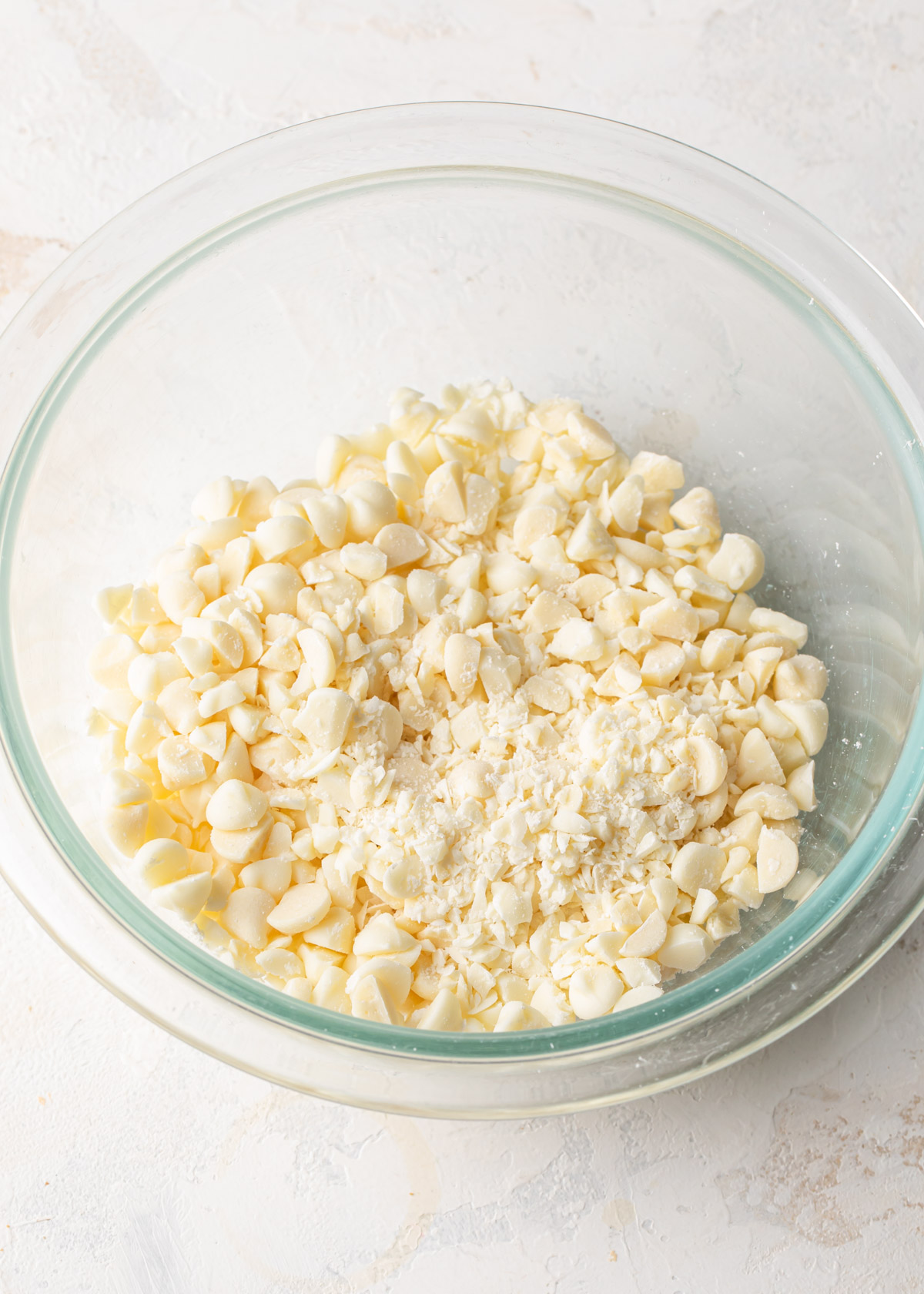 Chopped white chocolate in a glass bowl
