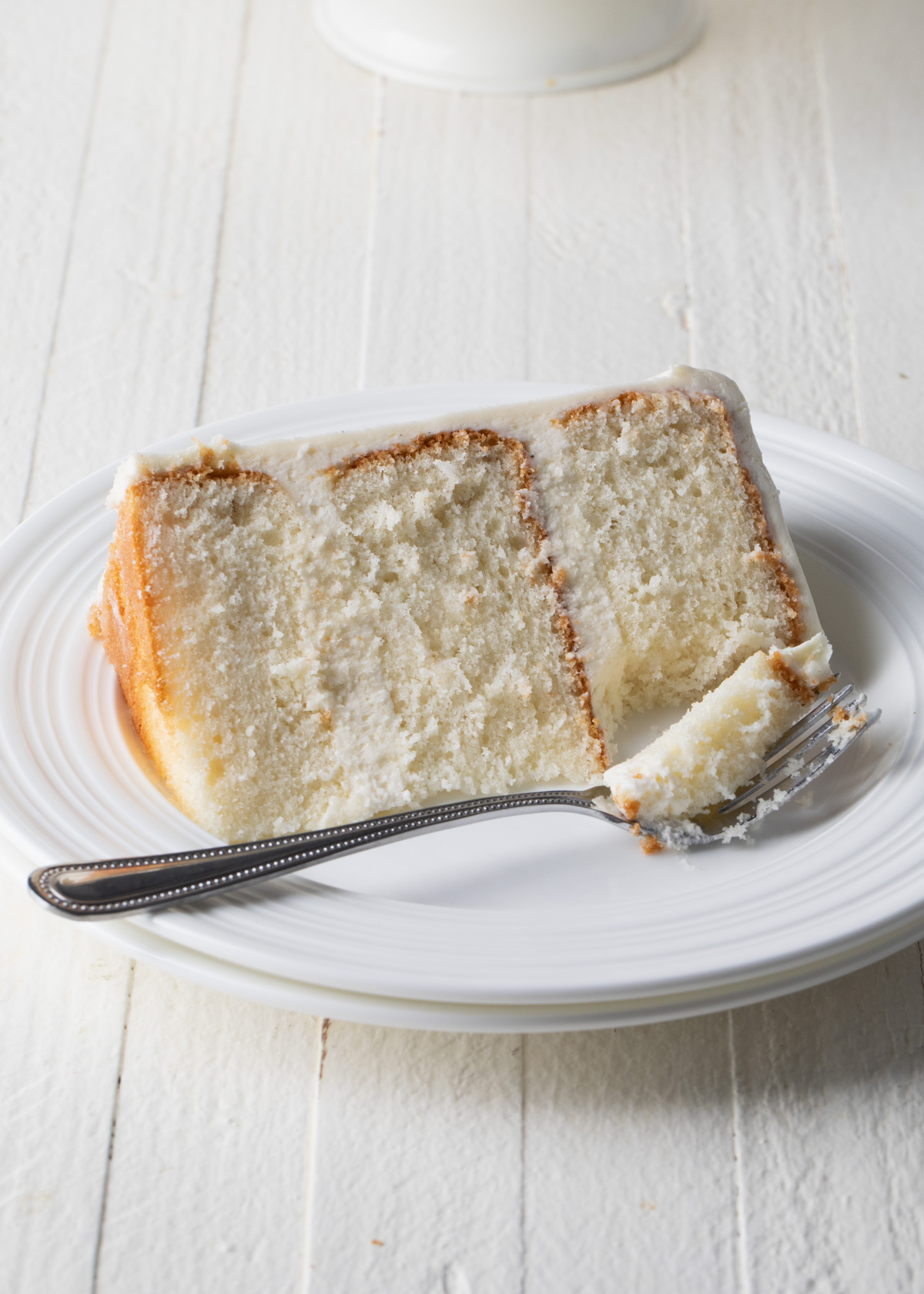 The tight, soft crumb on a slice of white velvet cake