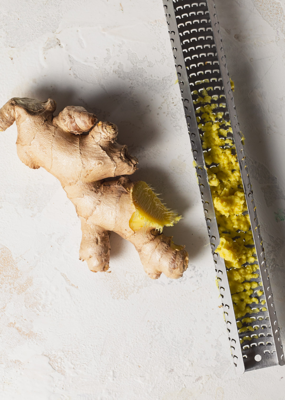 Grating fresh ginger with a microplane