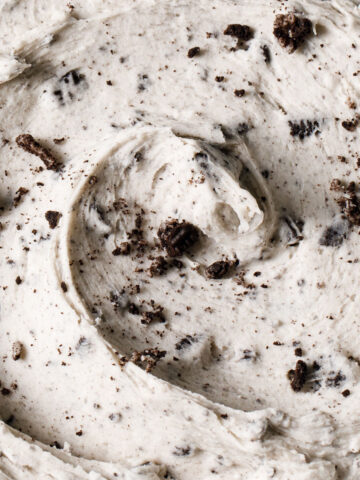 A close-up of a bowl of Oreo buttercream with crushed cookies on top