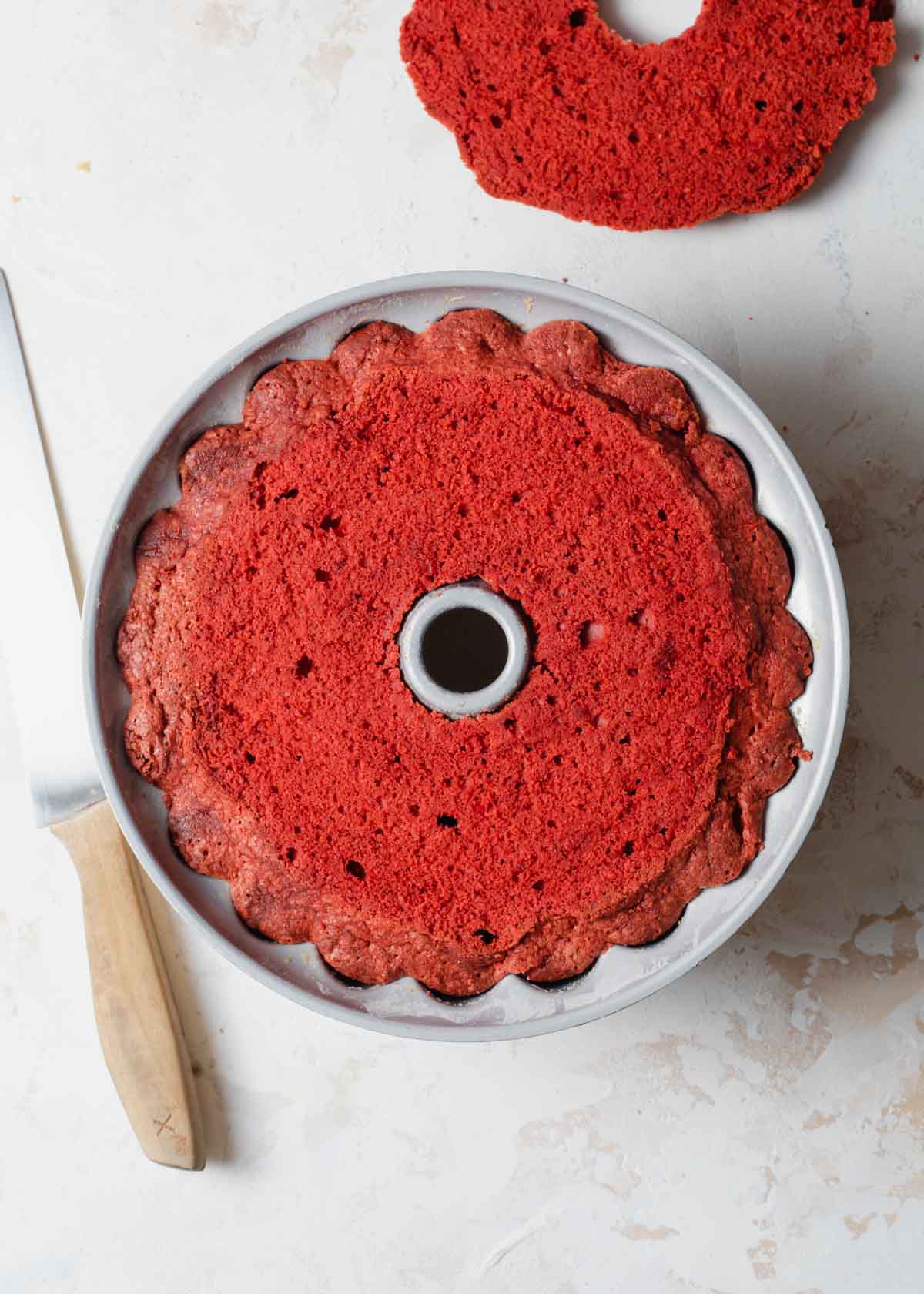 A close up of a sliced open red velvet cake