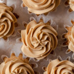 Creamy biscoff buttercream piped on top of cupcakes