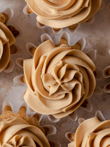 Creamy biscoff buttercream piped on top of cupcakes