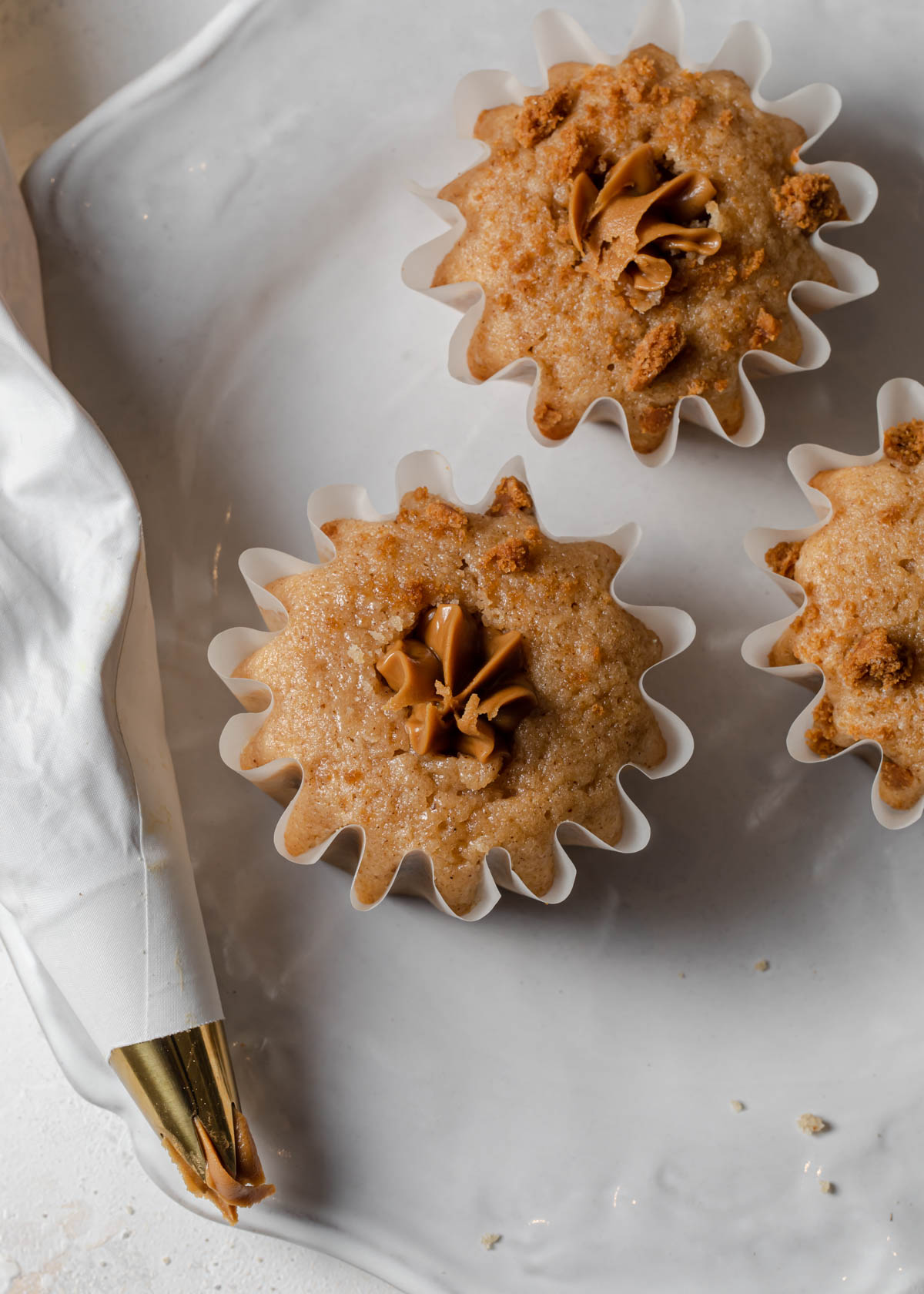 Fill cupcakes with a piping bag of cookie butter spread