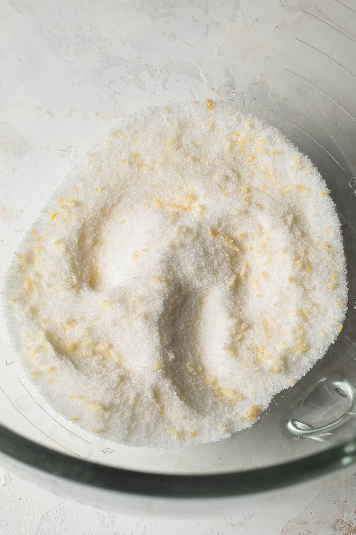 A close-up of lemon zest mixed with granulated sugar