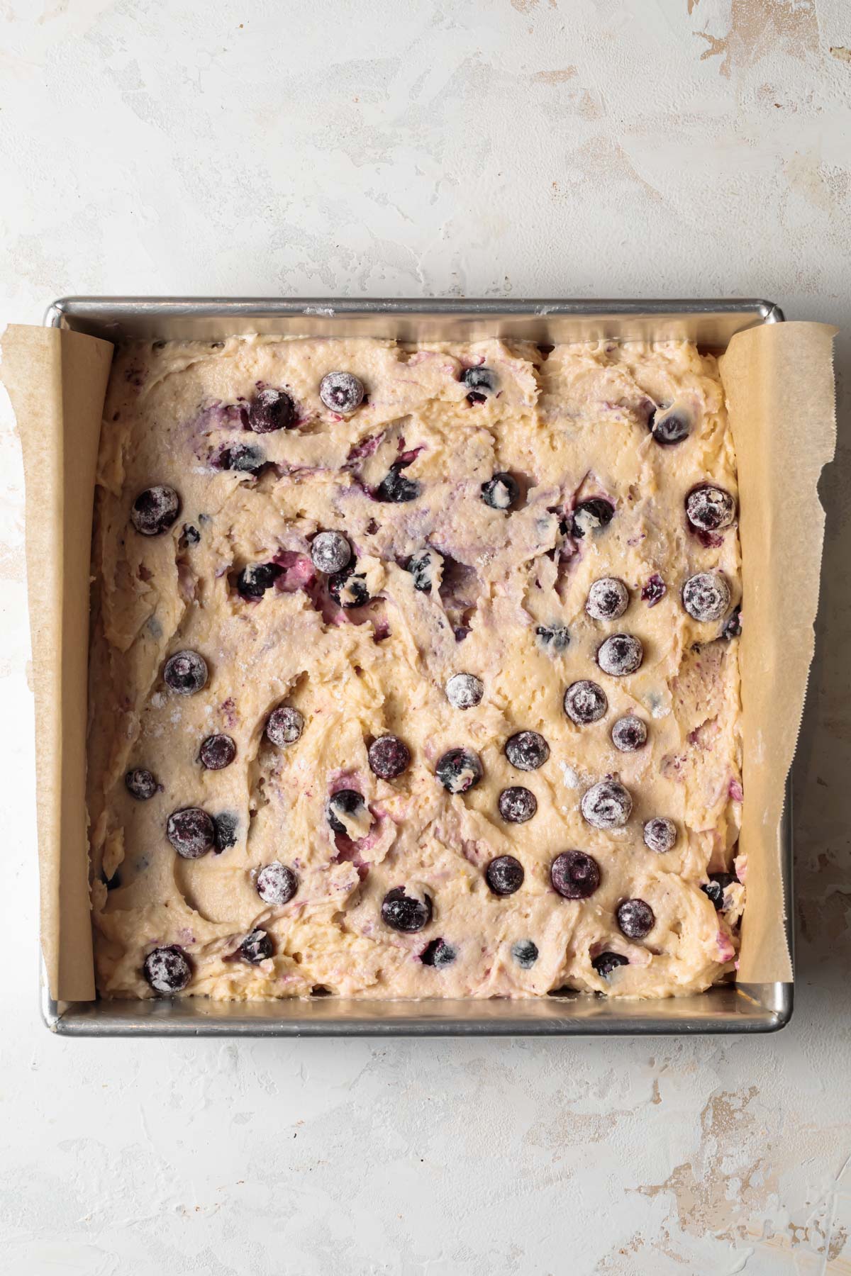 Blueberry coffee cake batter in a baking pan
