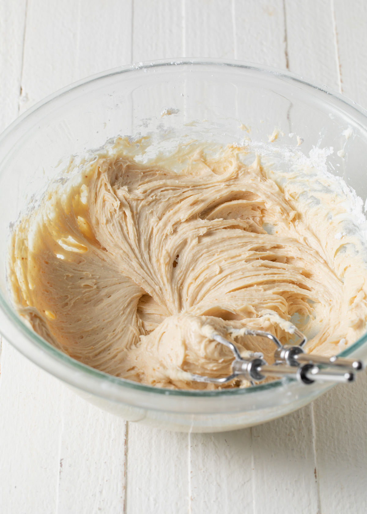 Fluffy peanut butter cream cheese frosting in a mixing bowl