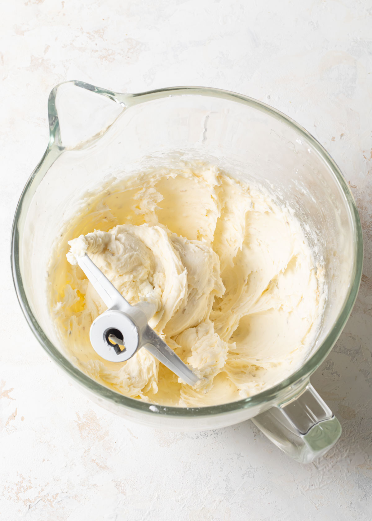 Mixing buttercream in a glass bowl