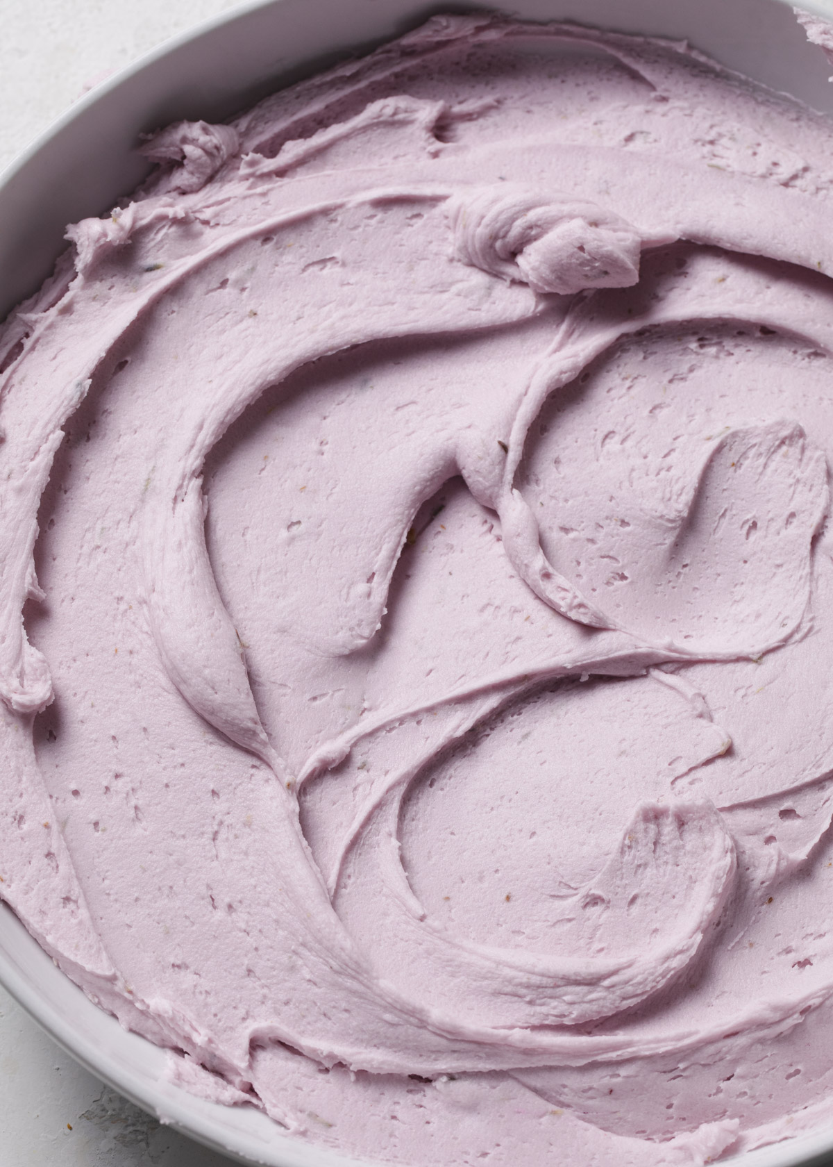 A bowl of swirly lavender buttercream frosting