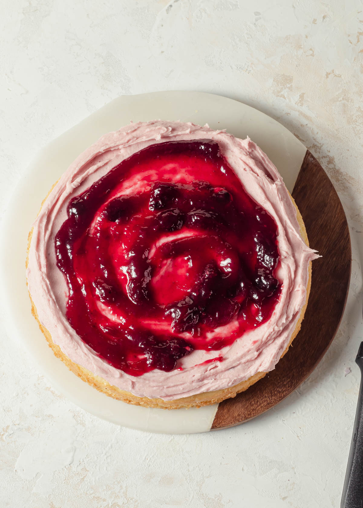 Raspberries jam swirled on top of a cake 
